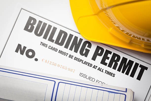 Sample building permit document and hardhat